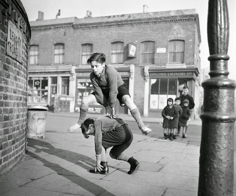 A group of children playing leap frog in the street 1950_Photo by Bill Brandt_2